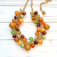Chunky beaded necklace in fall colors for women. Orange statement necklace.