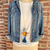 Triceratops pendant necklace for women. Dinosaur charm necklace on a gold chain.