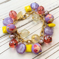 Lenora Dame bracelet. Purple and yellow beaded bracelet with beads wire wrapped on a gold plated steel chain with lobster clasp.