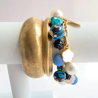 Lenora Dame bracelet stacked with gold bangle bracelets for bracelet layering inspiration.