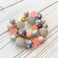 Lenora Dame chunky bracelet with pink, peach, grey and silver beads on a gold chain.