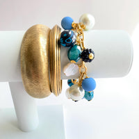 Lenora Dame bracelet stacked with gold bangle bracelets for bracelet layering inspiration.