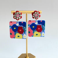 Floral drop earrings with square piece with flower design hanging from red rhinestone flower post earrings. Lenora Dame jewelry.