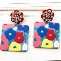 Floral drop earrings with square piece with flower design hanging from red rhinestone flower post earrings. Lenora Dame jewelry.