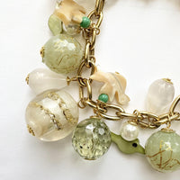 Chunky charm bracelet with a mix of light green, clear, and white beads on a gold chain with Lenora Dame hangtag. Lenora Dame jewelry made in USA.
