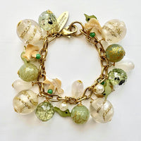 Chunky charm bracelet with a mix of light green, clear, and white beads on a gold chain with Lenora Dame hangtag. Lenora Dame jewelry made in USA.