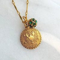 Gold zodiac pendant with a rhinestone bead charm hung on gold bar chain. Zodiac necklace for women. Cancer astrology pendant necklace.