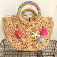 Straw handbag with round handle embellished with hand painted lobster and seashells. Summer tote bag for women.