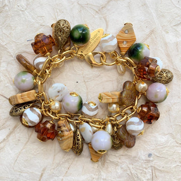 Gold charm bracelet with tan, gold, white, and brown beads. Chunky gold charm bracelet for women.