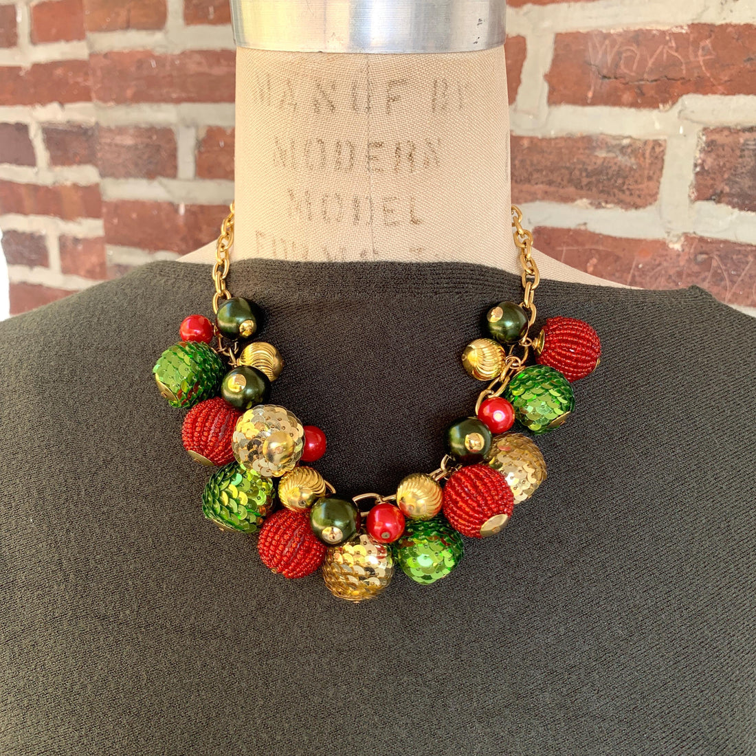 Red and green festive sequin beaded Christmas necklace. Womens Christmas necklace with red, green and gold round beads hung on a gold cable chain.