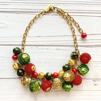 Red and green festive sequin beaded Christmas necklace. Womens Christmas necklace with red, green and gold round beads hung on a gold cable chain.