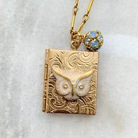 Gold locket necklace with brass owl metal stamping detail hung on a gold chain. Locket necklace for women.