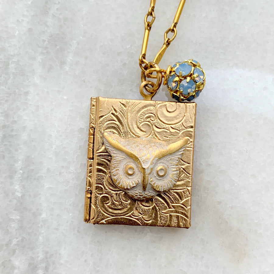 Gold locket necklace with brass owl metal stamping detail hung on a gold chain. Locket necklace for women.