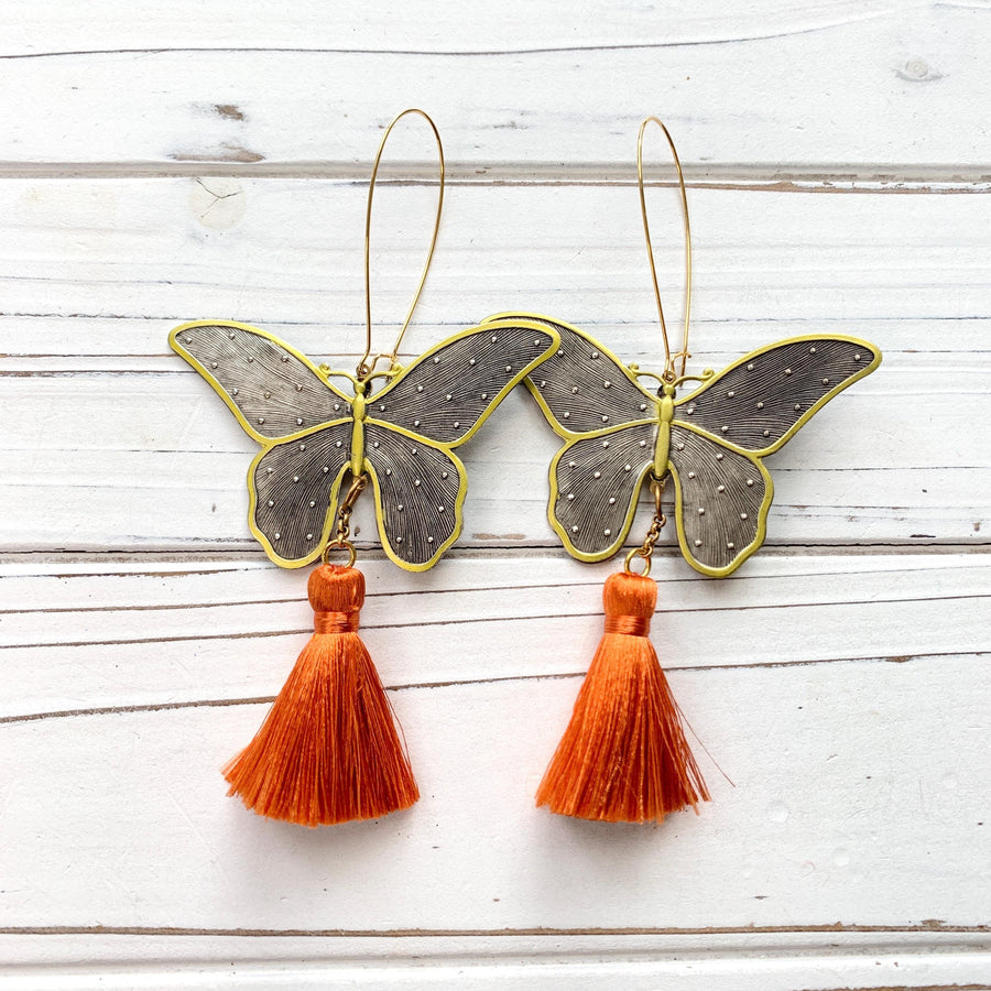 Butterfly earrings for women. Butterfly dangle earrings with silver butterflies and orange tassels.