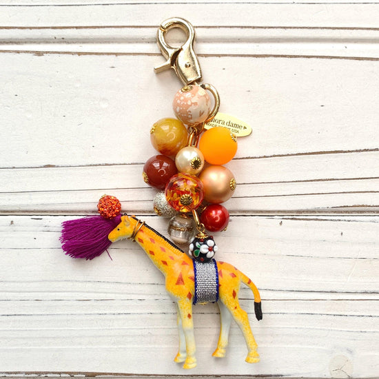 Cute beaded bag charm  with embellished giraffe figurine. Lenora Dame bag charms.