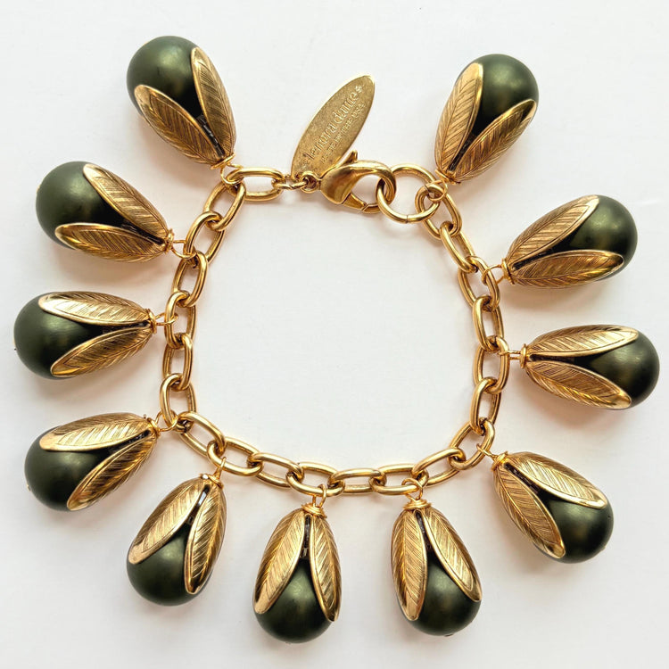 Gold chain bracelet with matte finish hunter green pearls encased in gold leaf bead caps. Lenora Dame bracelets handmade in the USA.