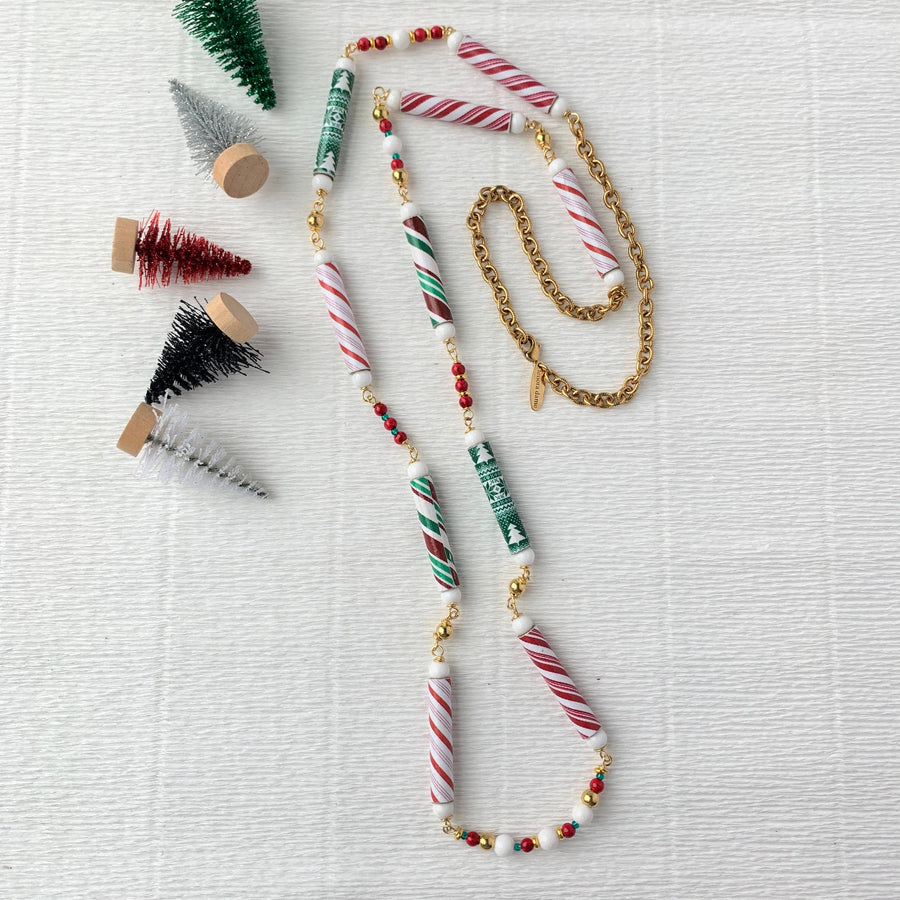 Long Christmas necklace with skinny beads that look like candy canes. Candy cane necklace for Christmas. 